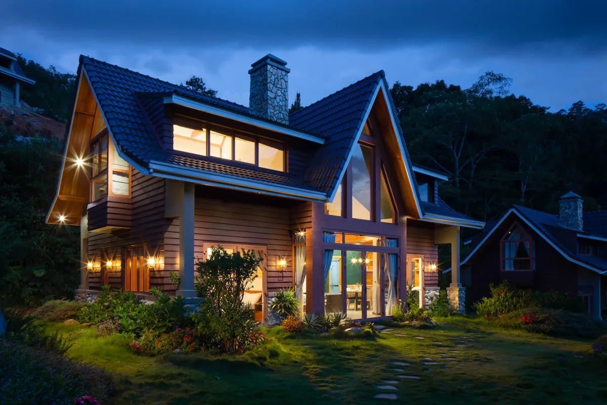 Craftsman home at night with a fresh tile roof