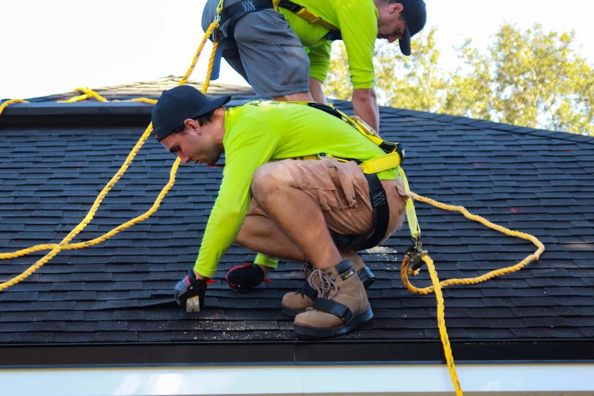 Apex crew installing architectural shingles on a steep roof