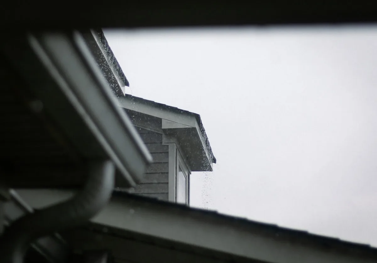 Seamless gutter run along a roofline in the rain