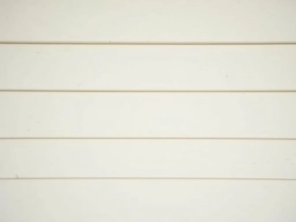 Clean white lap siding against a blue sky
