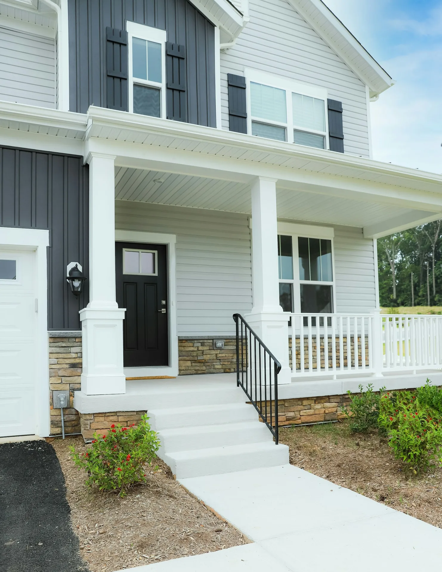 Bright windows on a shaded front porch